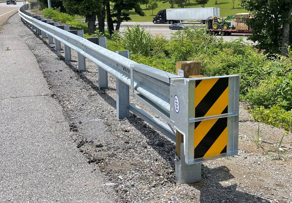 SGET End Terminal with W-Beam guardrail installed along roadway